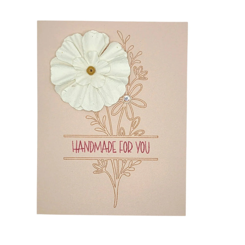 Handmade by Erika Liesel floral card on blush pink cardstock with a 3D white paper flower and gold foil lettering.