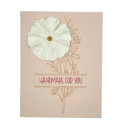 Handmade by Erika Liesel floral card on blush pink cardstock with a 3D white paper flower and gold foil lettering.
