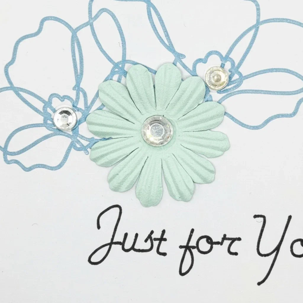 Handmade by Erika Liesel floral greeting card featuring a mint paper flower, blue line art, and crystal accents.