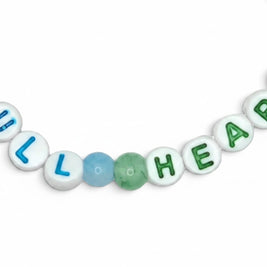 Handmade by Erika Liesel Full Heart stretch bracelet featuring blue, aqua, and green glass beads with letter beads.