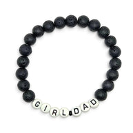 Handmade by Erika Liesel men's stretch bracelet featuring matte black lava stone beads and white Girl Dad letter beads