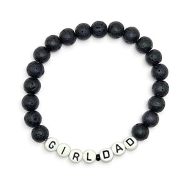 Handmade by Erika Liesel men's stretch bracelet featuring matte black lava stone beads and white Girl Dad letter beads