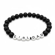 Handmade by Erika Liesel men's stretch bracelet featuring matte black lava stone beads and white Girl Dad letter beads.