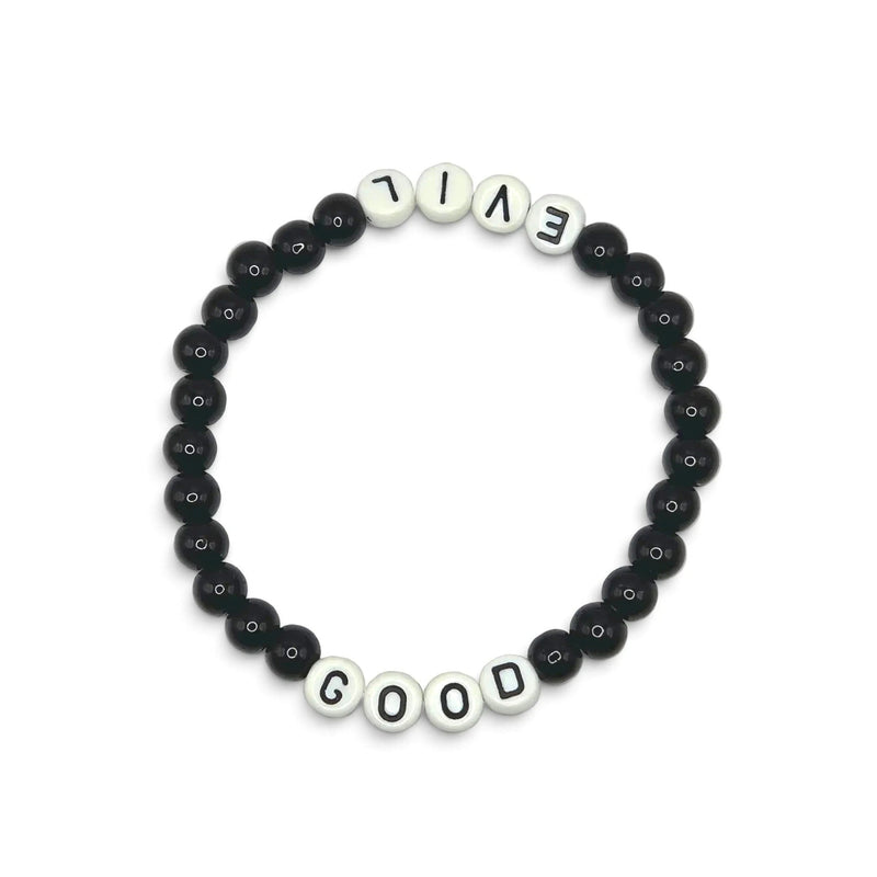 Handmade by Erika Liesel Good & Evil stretch bracelet with black glass beads and white letter beads on elastic cord.