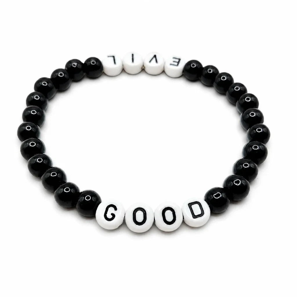 Handmade by Erika Liesel Good & Evil stretch bracelet with black glass beads and white letter beads on elastic cord.