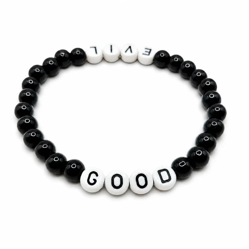 Handmade by Erika Liesel Good & Evil stretch bracelet with black glass beads and white letter beads on elastic cord.