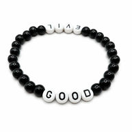 Handmade by Erika Liesel Good & Evil stretch bracelet with black glass beads and white letter beads on elastic cord.
