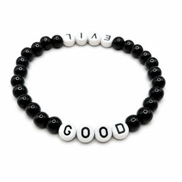 Handmade by Erika Liesel Good & Evil stretch bracelet with black glass beads and white letter beads on elastic cord.