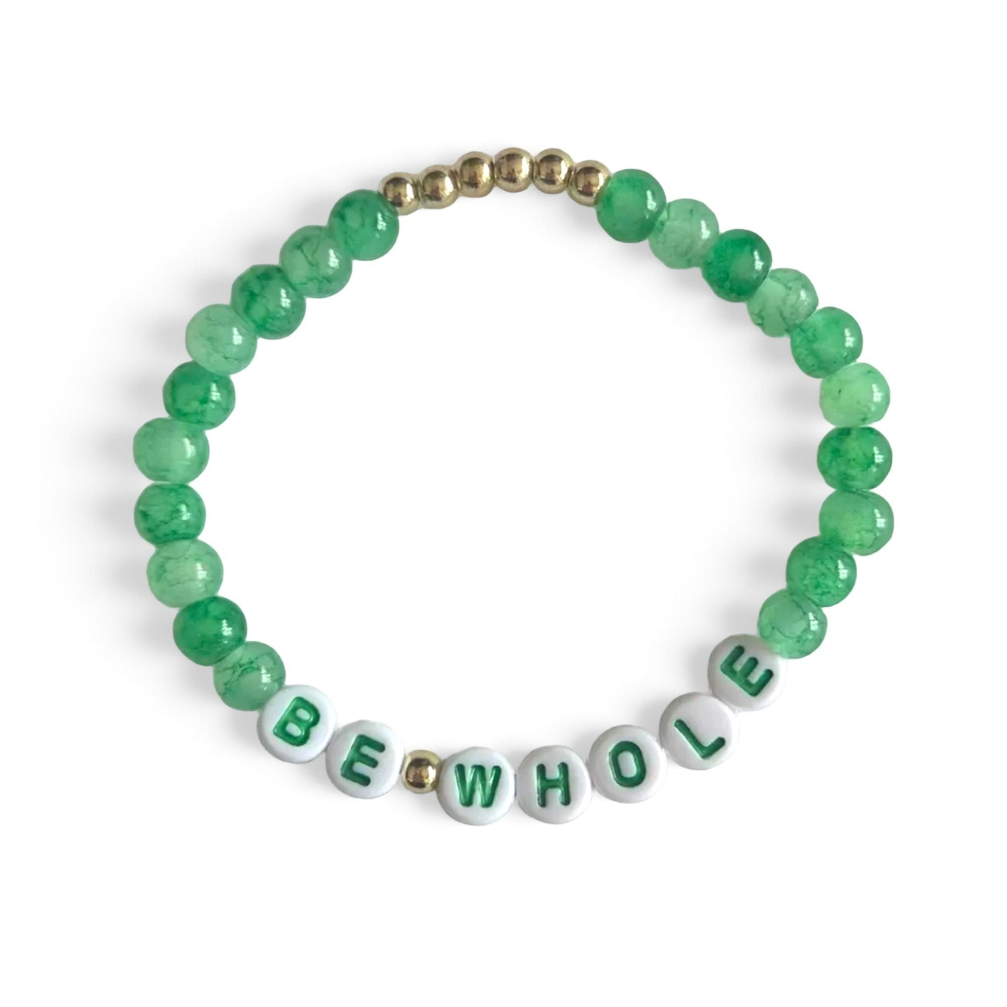 Handmade by Erika Liesel Be Whole elastic bracelet with green glass beads and white letter beads on a white background
