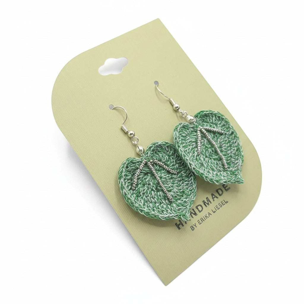 Handmade by Erika Liesel green crochet leaf earrings with delicate glass bead accents and silver hooks on display card