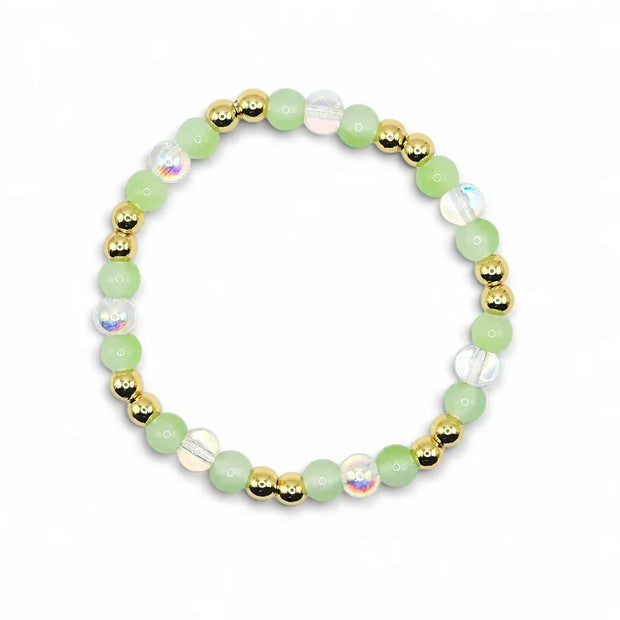 Handmade by Erika Liesel spring bracelet featuring green glass beads, iridescent crystals, and 18K gold-plated accents.