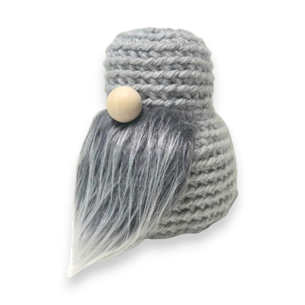 Handmade by Erika Liesel grey crochet gnome base with a soft faux fur beard and a wooden nose for seasonal decor.