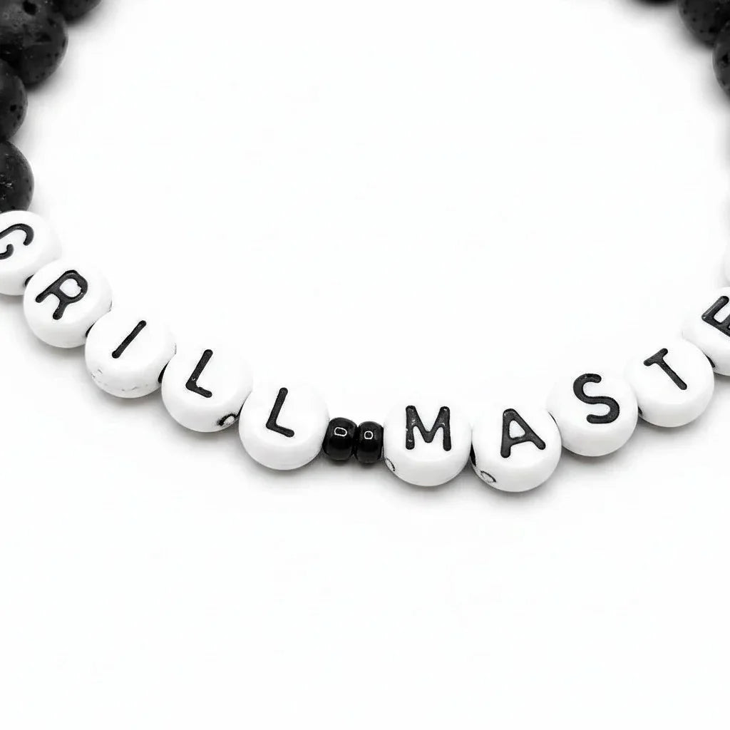 Handmade by Erika Liesel Grill Master bracelet with matte black lava stone beads and white letter beads on elastic