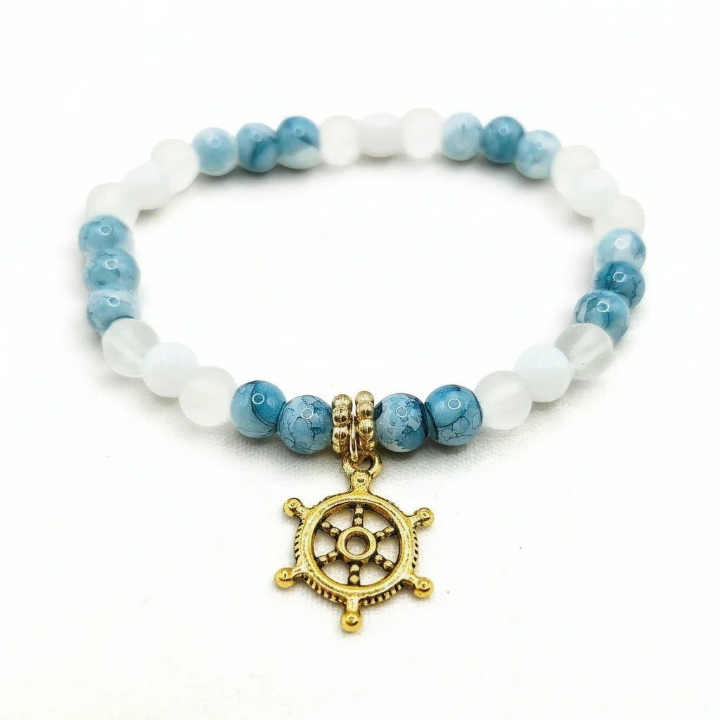 Handmade by Erika Liesel Harbor Bracelet with white and blue marbled glass beads and a gold-tone ship wheel charm.