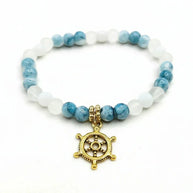 Handmade by Erika Liesel Harbor Bracelet with white and blue marbled glass beads and a gold-tone ship wheel charm.