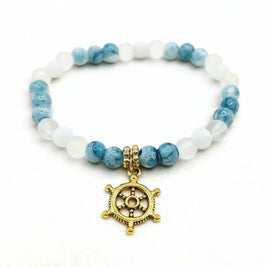 Handmade by Erika Liesel Harbor Bracelet with white and blue marbled glass beads and a gold-tone ship wheel charm.