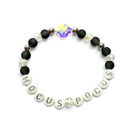 Handmade by Erika Liesel Hocus Pocus stretch bracelet with matte black beads, silver letters, and iridescent crystal.