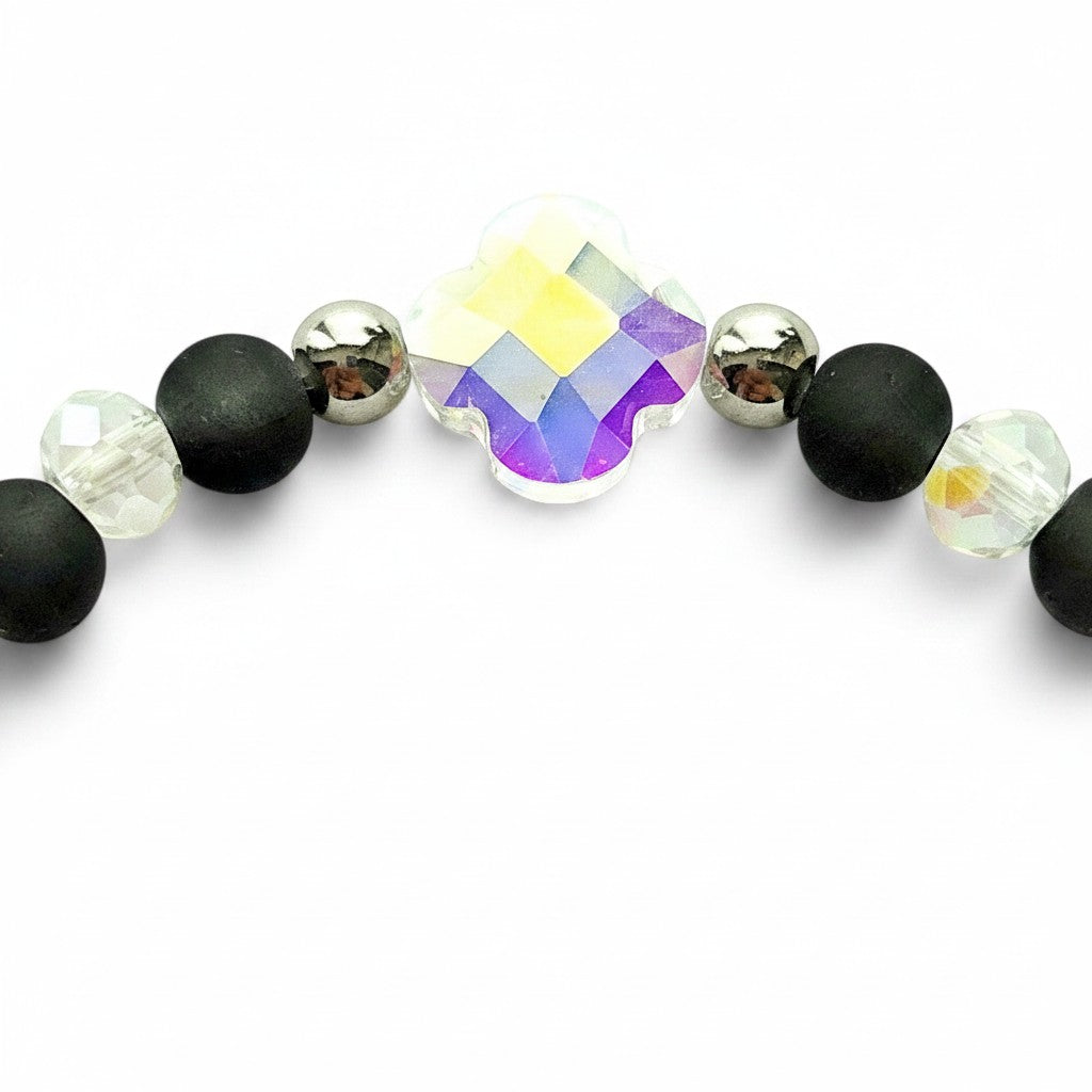 Handmade by Erika Liesel Hocus Pocus bracelet with matte black beads, silver accents, and iridescent crystal charm.