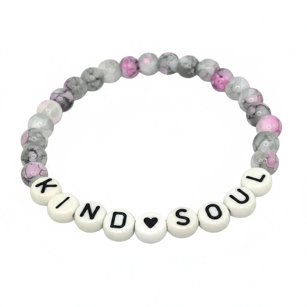 Handmade by Erika Liesel Kind Soul stretch bracelet with pink, gray, and white marbled glass beads on white background