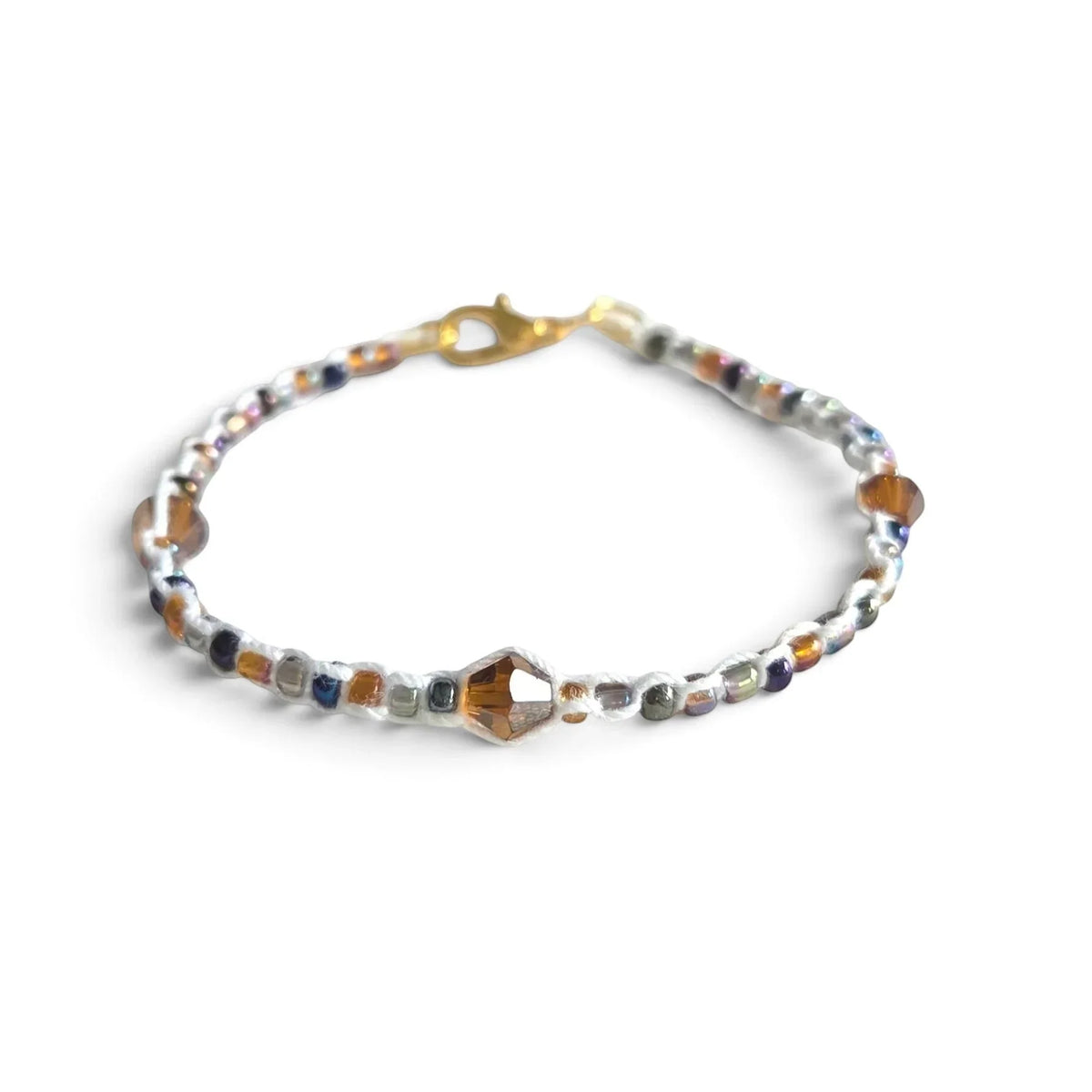 Handmade beaded bracelet with colorful crystals and gold clasp, perfect for cozy gifting