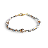 Handmade beaded bracelet with colorful crystals and gold clasp, perfect for cozy gifting