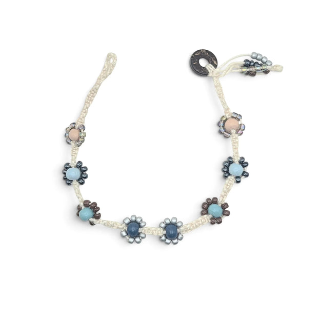 Handmade crochet necklace with blue and beige flower beads, macrame cord, and wooden toggle clasp