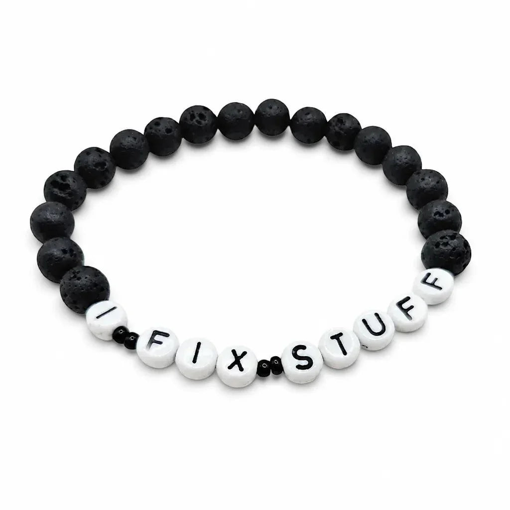 Handmade by Erika Liesel men's 8-inch stretch bracelet featuring matte black lava stone beads and I FIX STUFF text.
