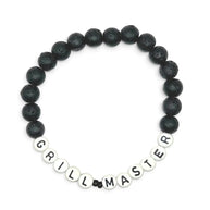 Handmade by Erika Liesel men's stretch bracelet with 8mm matte black lava stone beads and white Grill Master letter beads