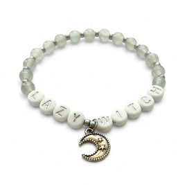Handmade by Erika Liesel Lazy Witch bracelet with gray glass beads, silver letter beads, and a crescent moon charm.