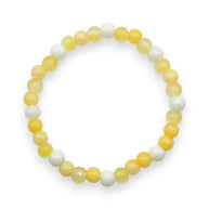 Handmade by Erika Liesel stretch bracelet featuring 6mm lemon yellow and milky white glass beads in a circular pattern.