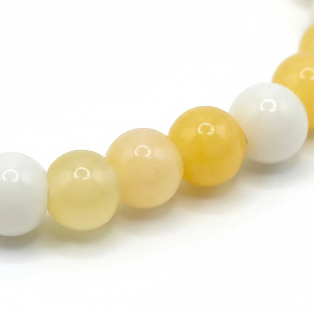 Handmade by Erika Liesel stretch bracelet featuring 6mm lemon yellow and milky white glass beads on elastic cord.