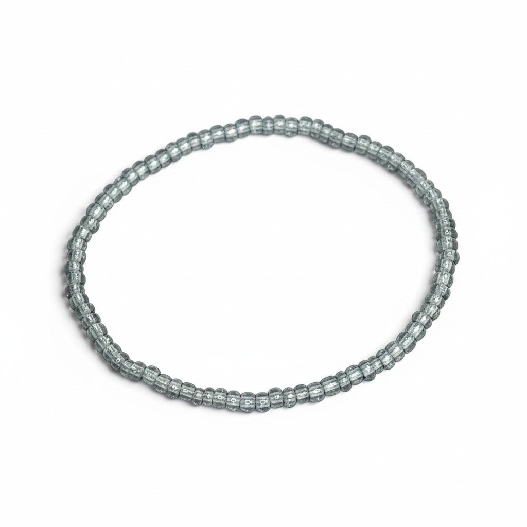 Handmade by Erika Liesel light blue translucent glass bead stretch bracelet on a white background