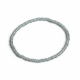 Handmade by Erika Liesel light blue translucent glass bead stretch bracelet on a white background