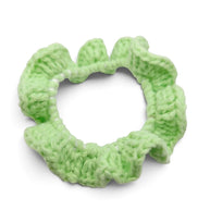 Handmade by Erika Liesel light green crochet scrunchie with a soft, textured yarn finish for a polished hairstyle.
