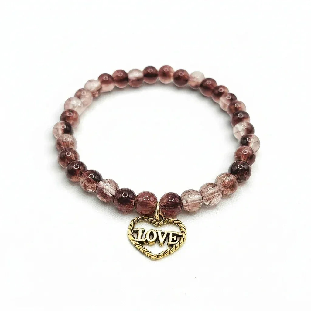 Handmade by Erika Liesel stretch bracelet with smoky brown crackle glass beads and a gold-tone Love heart charm.