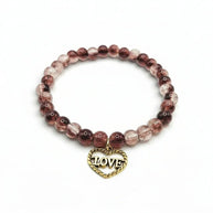 Handmade by Erika Liesel stretch bracelet with smoky brown crackle glass beads and a gold-tone Love heart charm.