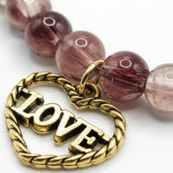 Handmade by Erika Liesel stretch bracelet with smoky brown crackle glass beads and a gold-tone Love heart charm.