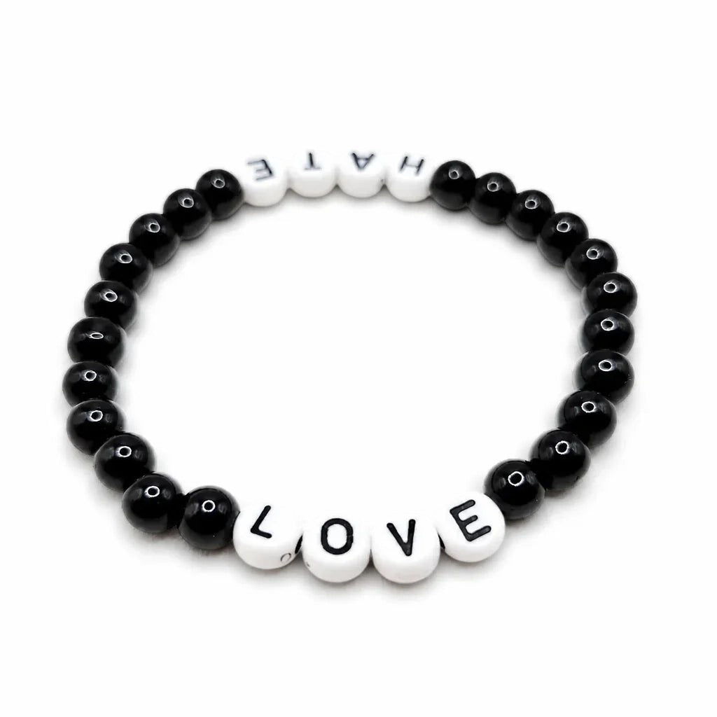 Handmade by Erika Liesel stretch bracelet with black glass beads and white letter beads spelling Love and Hate.