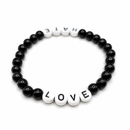 Handmade by Erika Liesel stretch bracelet with black glass beads and white letter beads spelling Love and Hate.