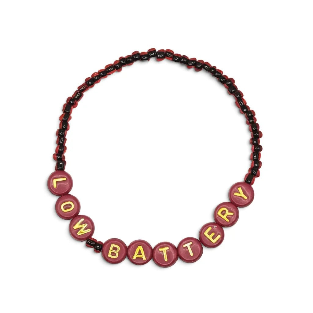 Handmade by Erika Liesel Low Battery bracelet with red glass beads and gold-foil letter beads on a stretch cord.