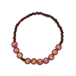 Handmade by Erika Liesel Low Battery bracelet with red glass beads and gold-foil letter beads on a stretch cord.