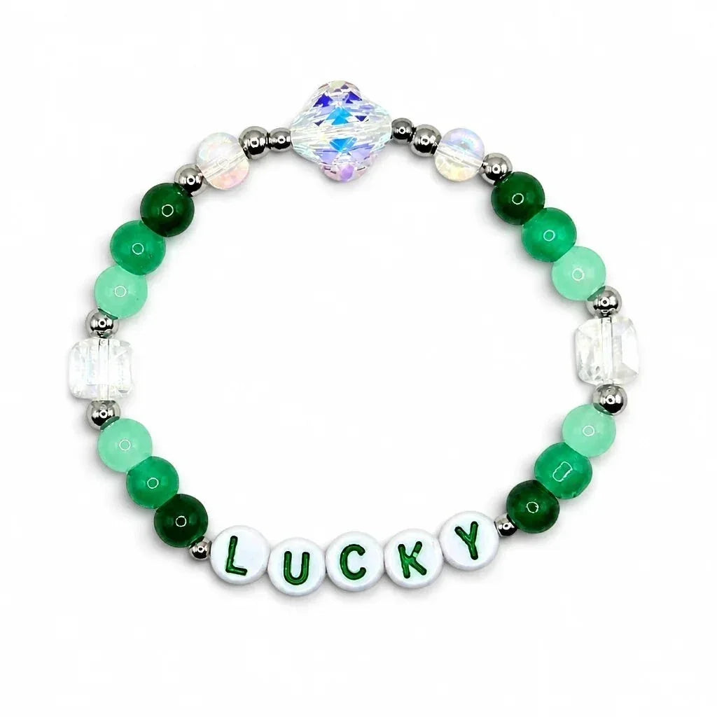 Handmade by Erika Liesel Lucky stretch bracelet with green crystal beads, sterling silver accents, and letter beads.