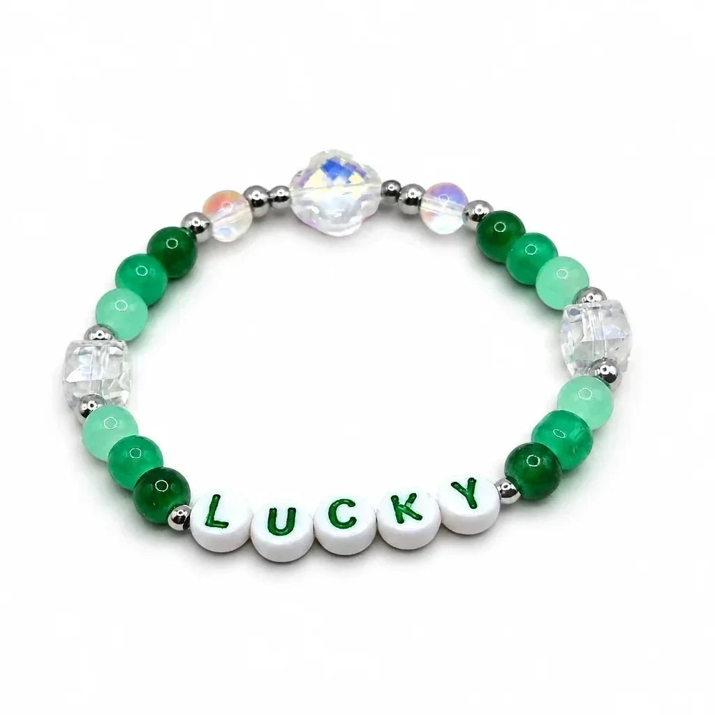 Handmade by Erika Liesel Lucky bracelet featuring green crystal glass beads, sterling silver accents, and letter beads.
