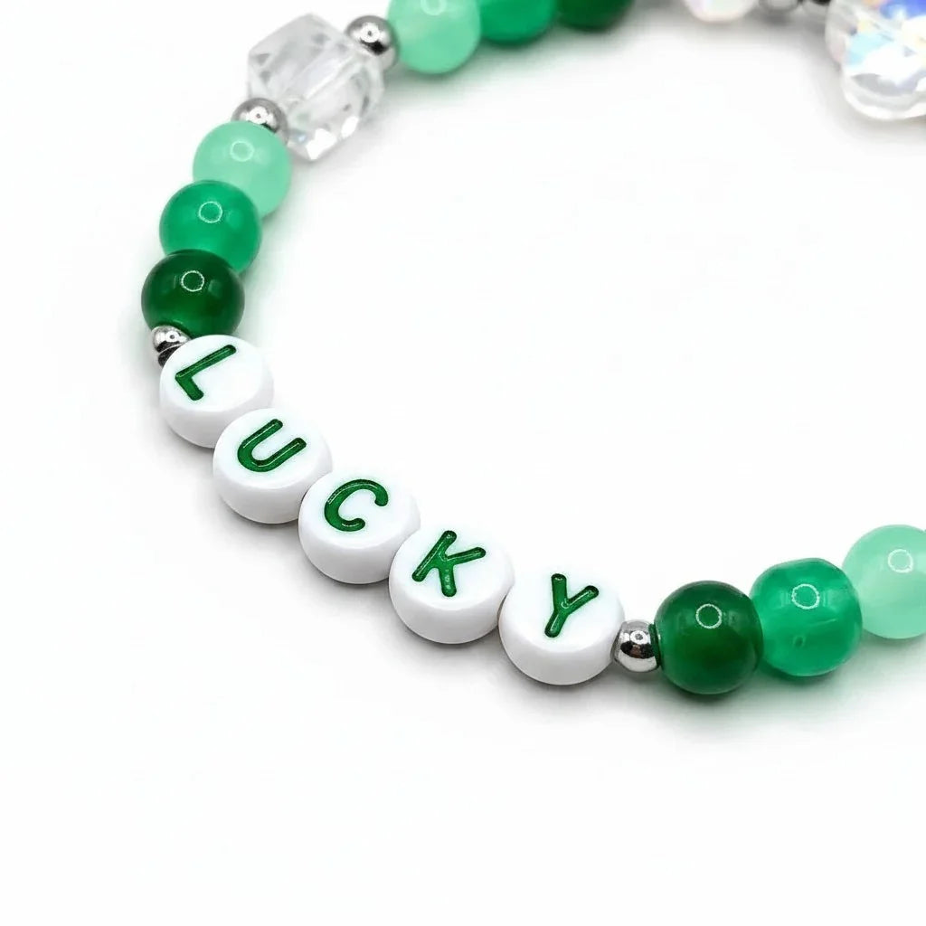 Handmade by Erika Liesel Lucky bracelet featuring green crystal beads, sterling silver accents, and letter beads.