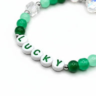 Handmade by Erika Liesel Lucky bracelet featuring green crystal beads, sterling silver accents, and letter beads.