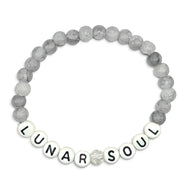 Handmade by Erika Liesel Lunar Soul stretch bracelet featuring gray marbled glass beads and white letter beads.