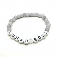 Handmade by Erika Liesel Lunar Soul bracelet featuring gray marbled glass beads and white lettered accent beads.