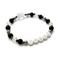 Handmade by Erika Liesel Magic stretch bracelet with matte black beads, silver letters, and iridescent crystals.