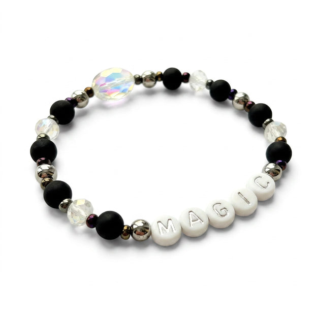 Handmade by Erika Liesel Magic stretch bracelet with matte black beads, silver letters, and iridescent crystals.