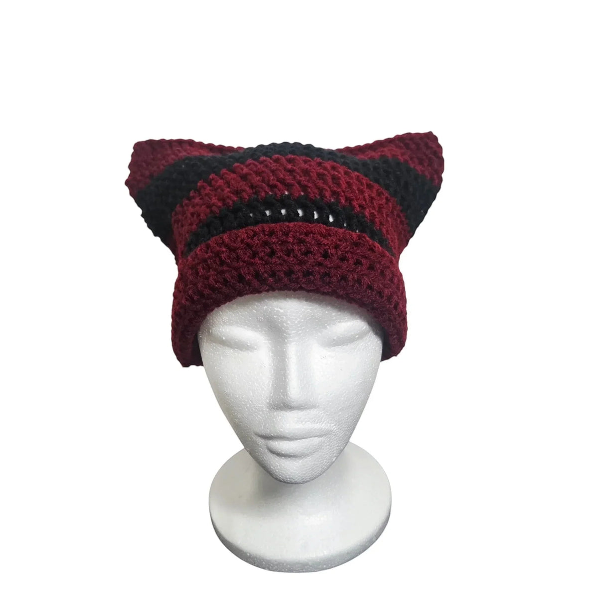 Handmade by Erika Liesel striped maroon and black crochet cat-ear beanie on a white mannequin head